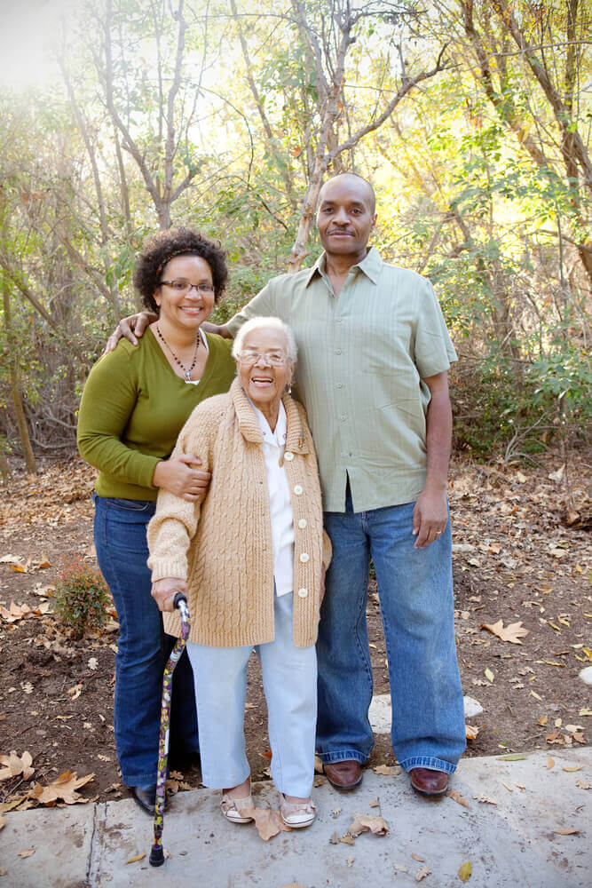Couple with elderly woman smiling