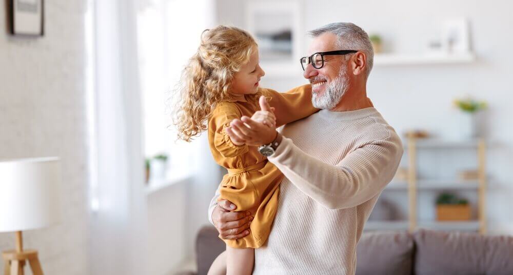 Grandpa dancing with young granddaughter
